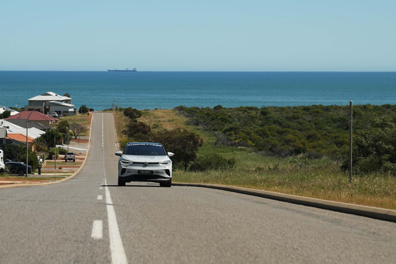 ID.4 driving on road with ocean in background