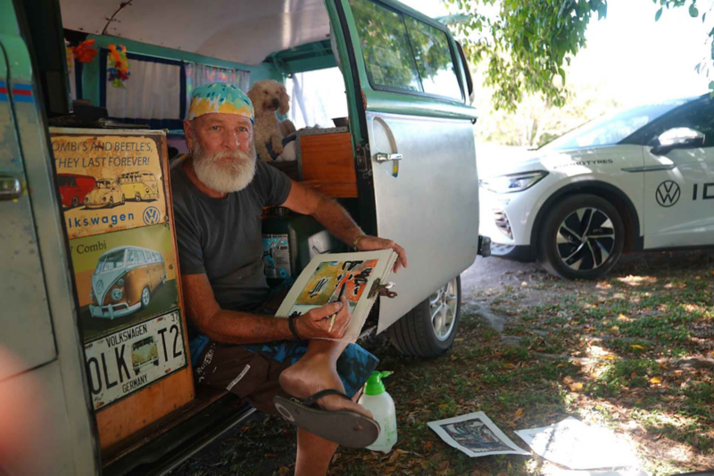 Man sat in doorway of VW campervan