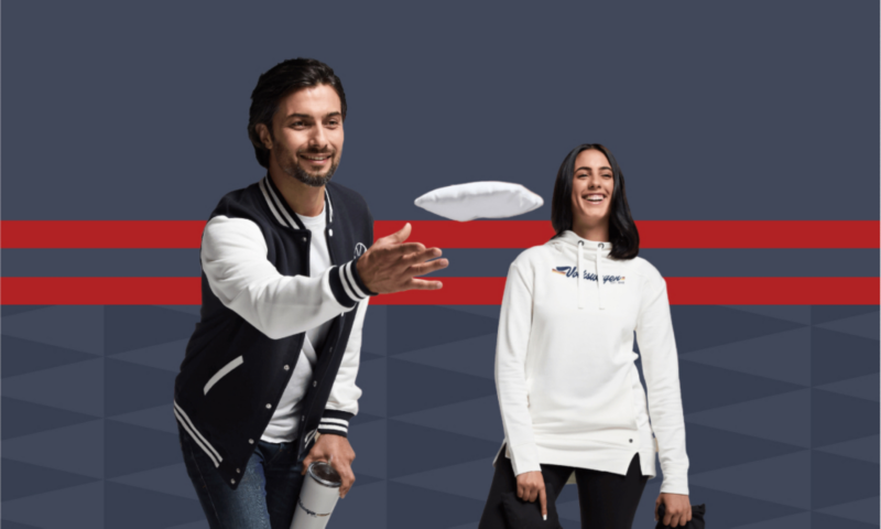 Man throwing an object, wearing VW attire