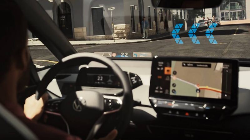 a windscreen that shows arrows on it in the distance to demonstrate augmented reality functionality on VW models