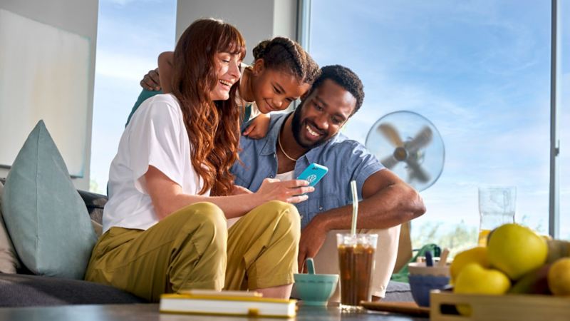 Une famille rassemblée dans le salon règle la ventilation stationnaire à distance