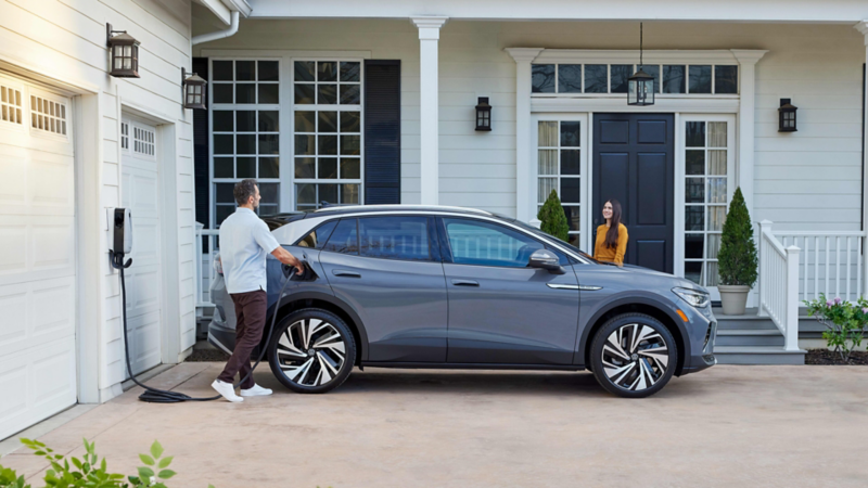 Man charging VW ID.4 at home.