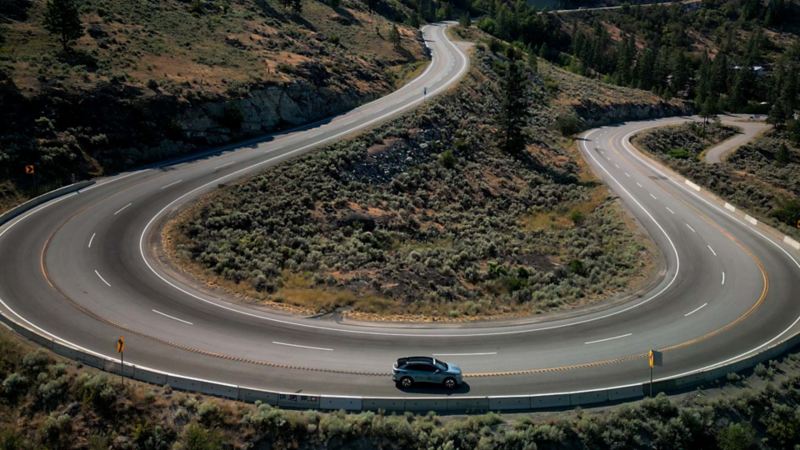 The VW ID.4 driving on a winding road.