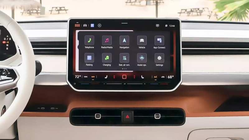 Car interior showing a large infotainment screen with various apps like Navigation and Charging, and digital climate controls at the bottom.