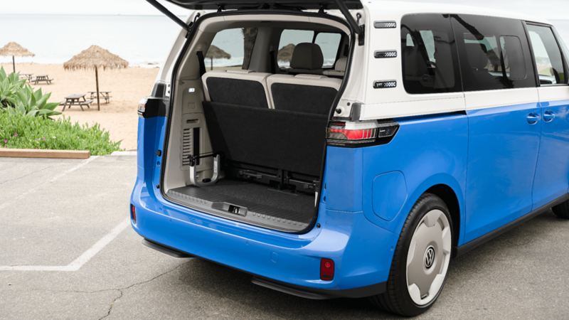 The Volkswagen ID. Buzz 2025 with its open rear liftgate, showcasing the spacious cargo area and "Easy Open" feature.