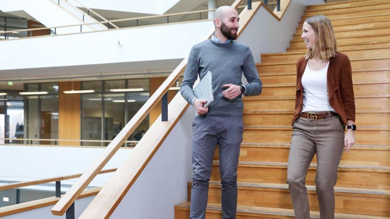 A woman and a man in conversation on the stairs