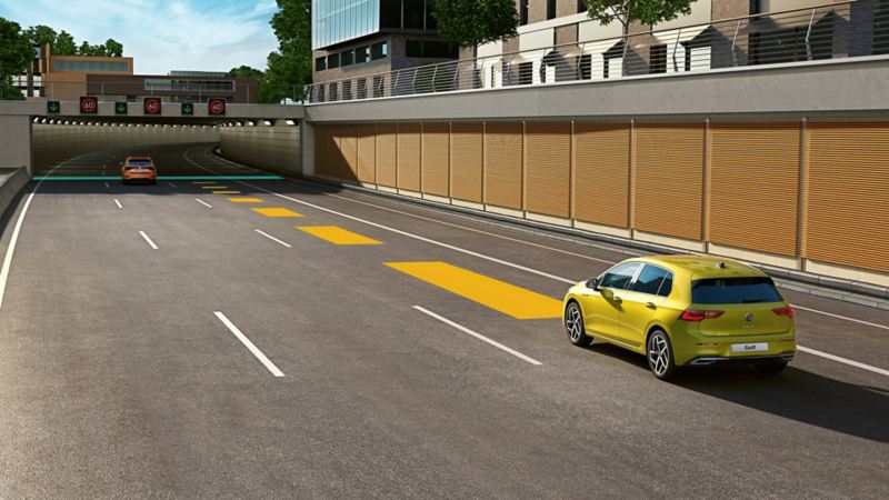 Yellow VW Golf in traffic, using the optional Adaptive Cruise Control ACC.