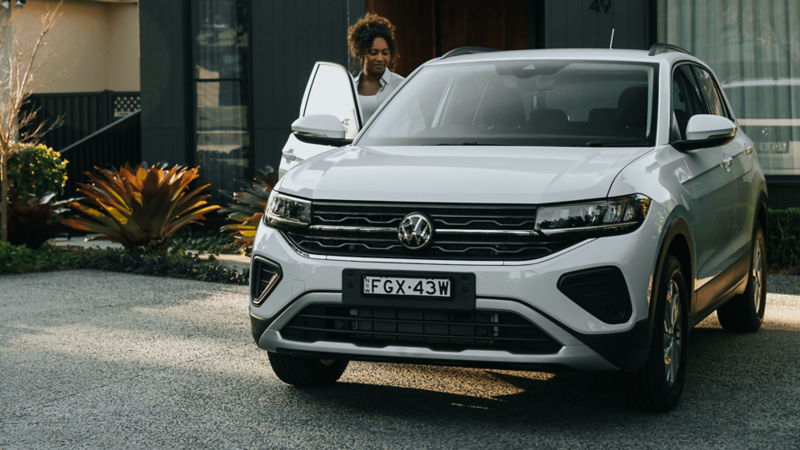 Woman entering white T-cross