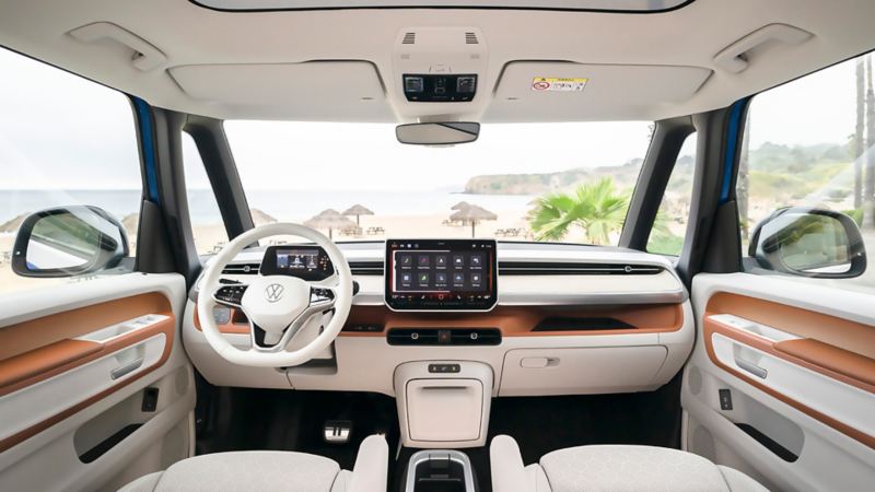 The interior of a 2025 Volkswagen ID. Buzz facing a beach view.