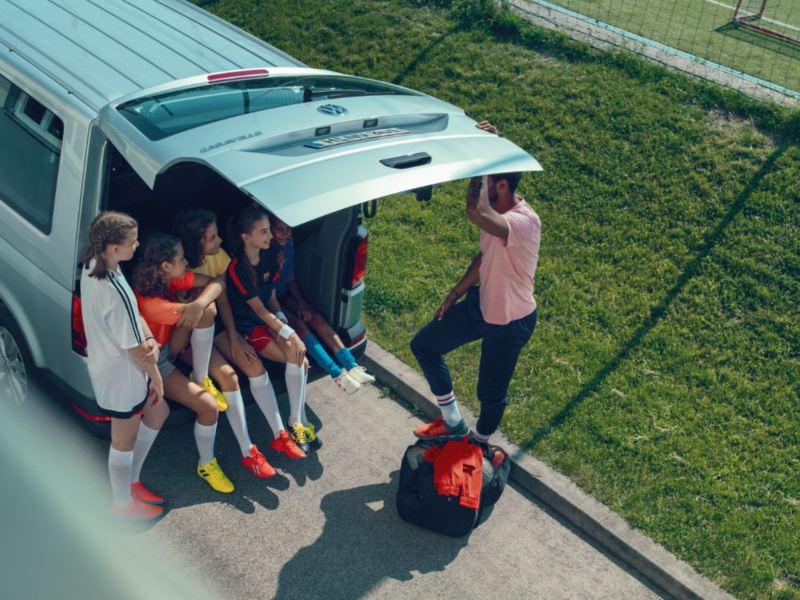 Kids sitting in the backseats of a VW Caravelle 6.1. after football practice