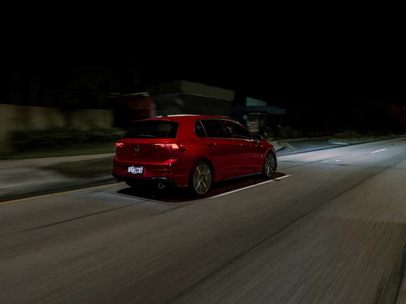 Red VW driving at night