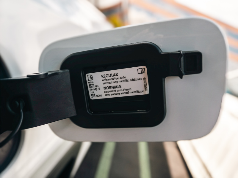 Image of the back of the 2027 Volkswagen Atlas fuel door which has a display of the recommended AKI fuel grade