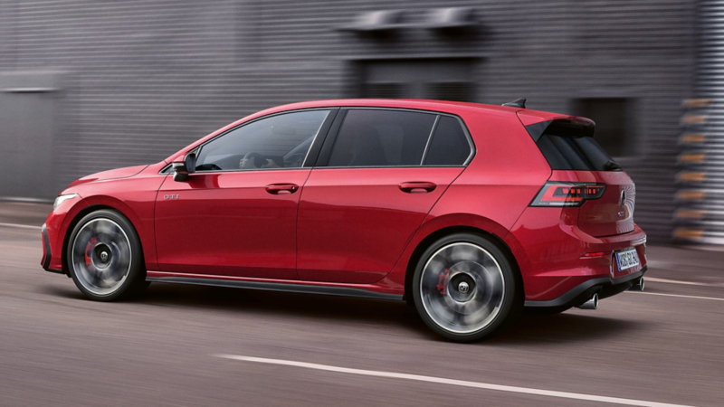 Side view of a red Golf GTI moving.