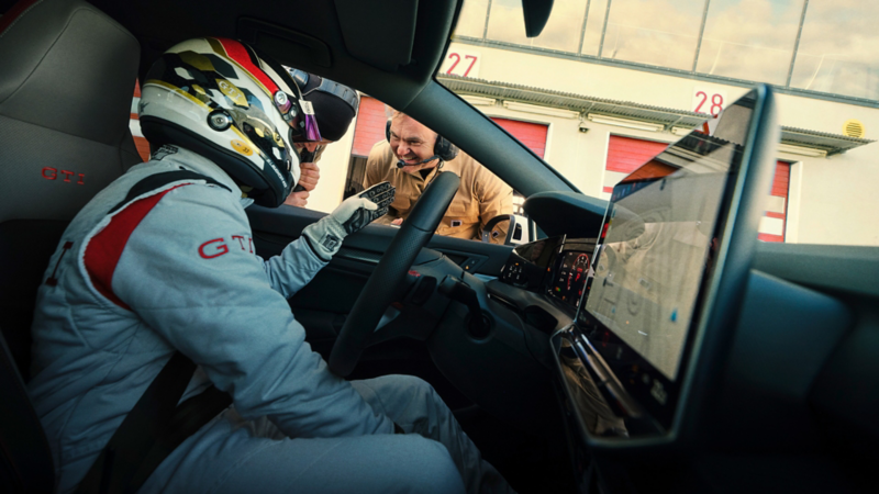 View from the passenger seat of the driver talking to a technician.