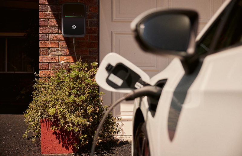 Car charging in front of house