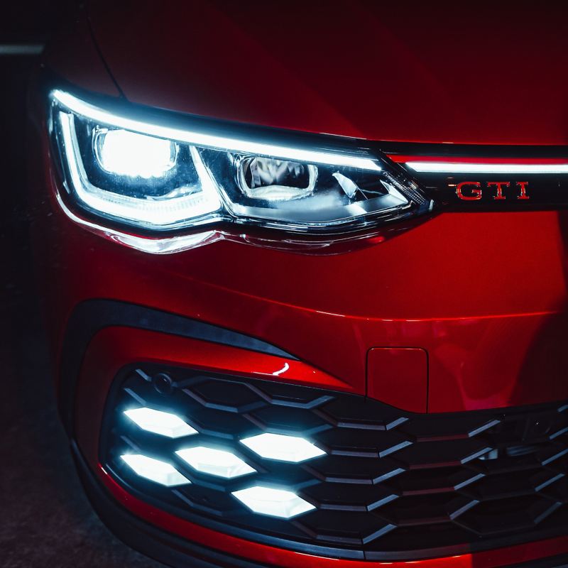 Close up on Volkswagen Golf GTI front grille and headlights.