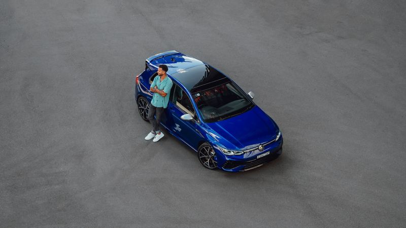 Top angle of the Volkswagen Golf R with a man beside