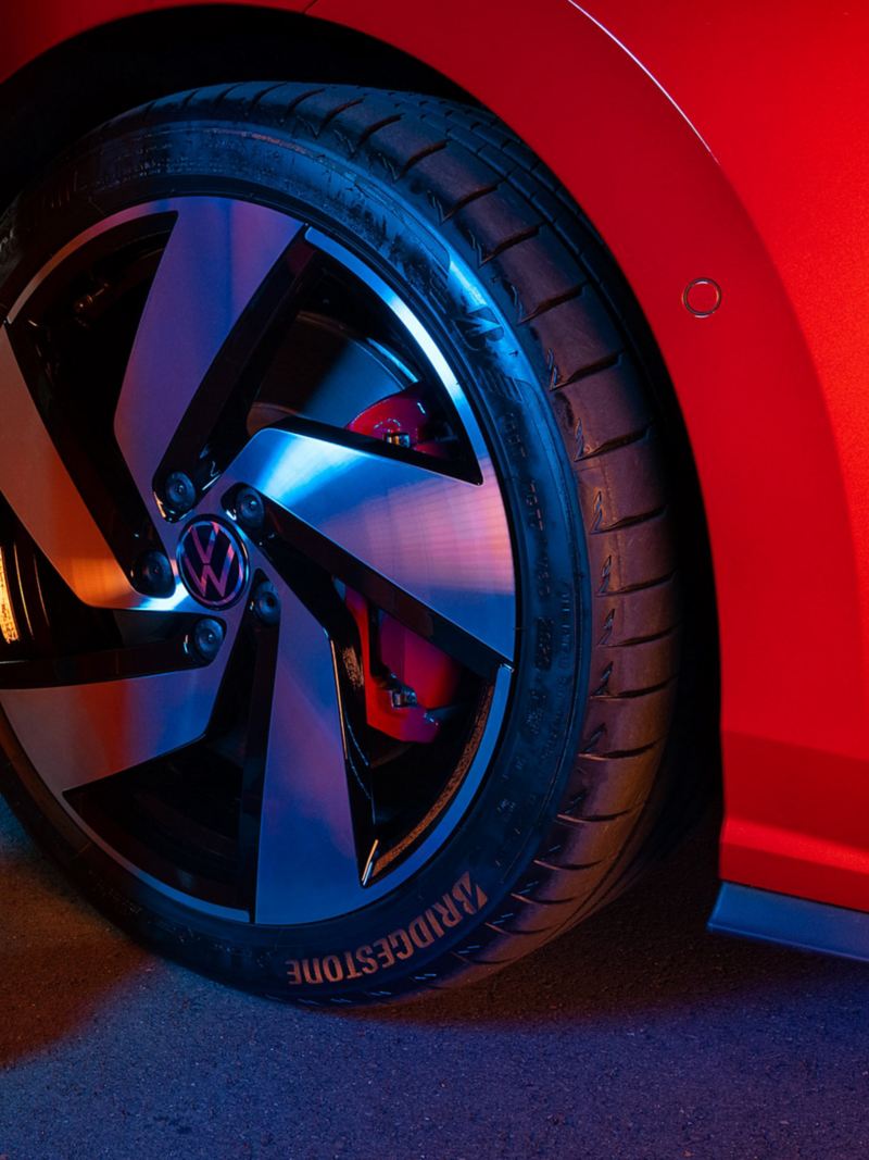 VW tyre with rim on a red car
