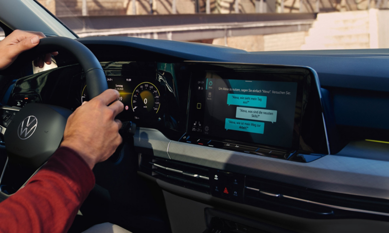 Innenansicht VW Golf Variant mit Blick auf optionales Innovision Cockpit mit großem Farbdisplay. Links umfassen zwei Hände das Lenkrad.