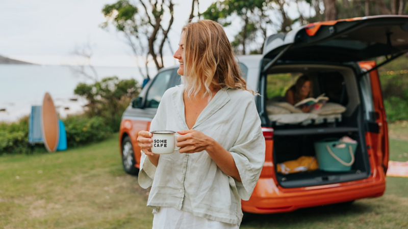 Woman camping in multivan