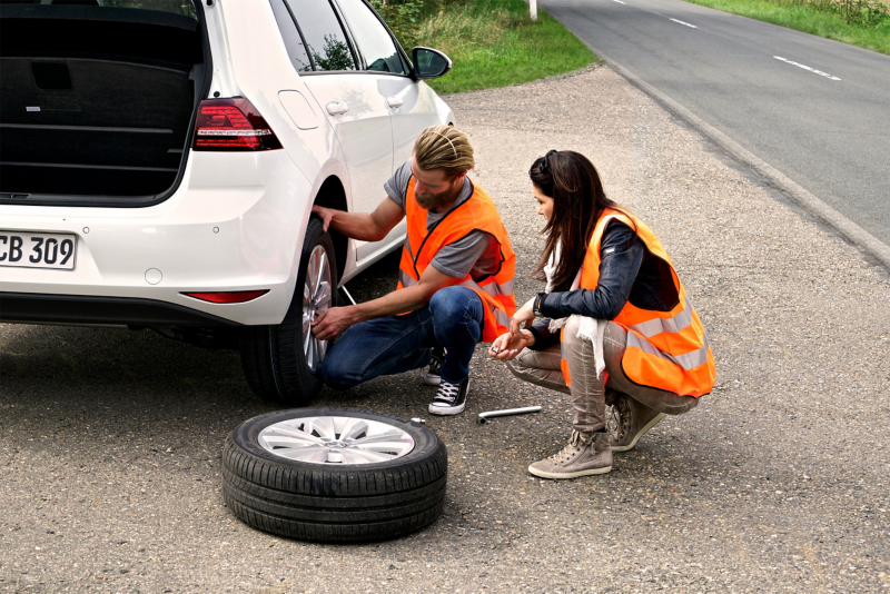 Volkswagen service  expert replacing the damaged rear wheel