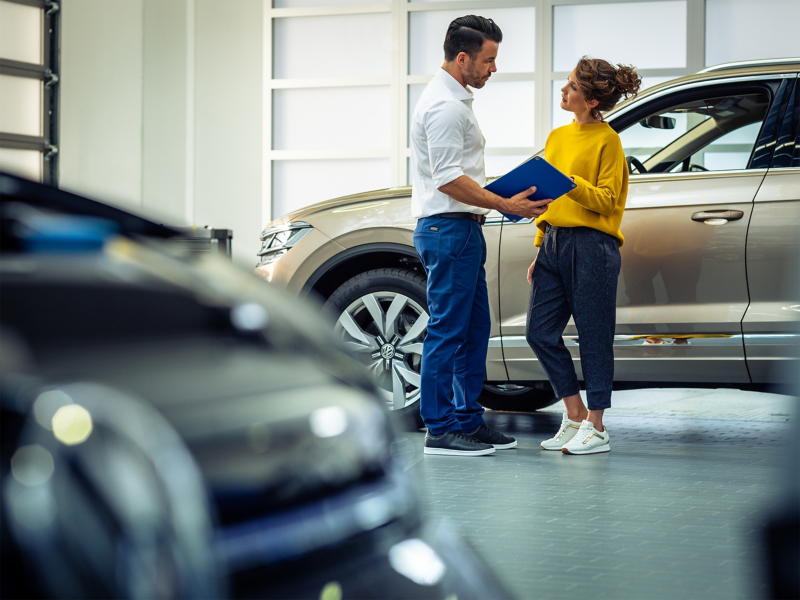 Man and woman talking in garage