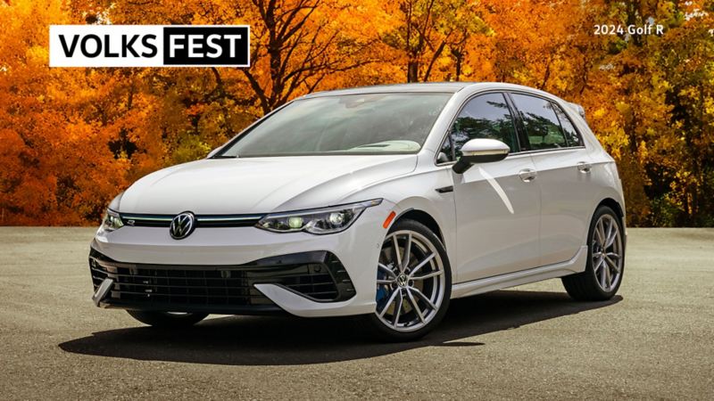 A white Volkswagen Golf R by a forest.