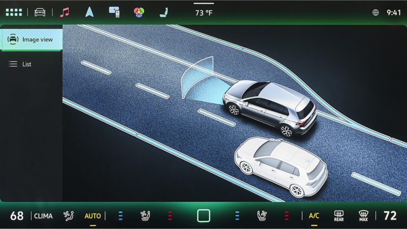 Volkswagen IQ.DRIVE dashboard display showing adaptive cruise control, lane assist, and blind spot monitoring in action.