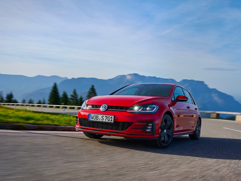 Red VW Golf 7 drives round a bend