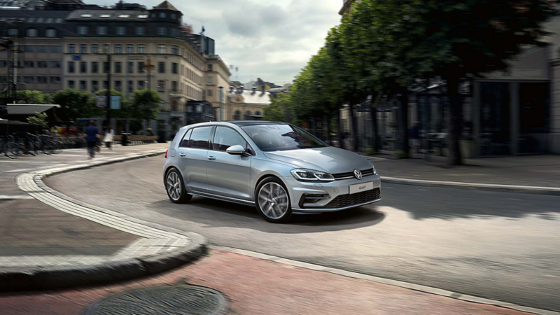 The Volkswagen Golf in silver driving around a corner