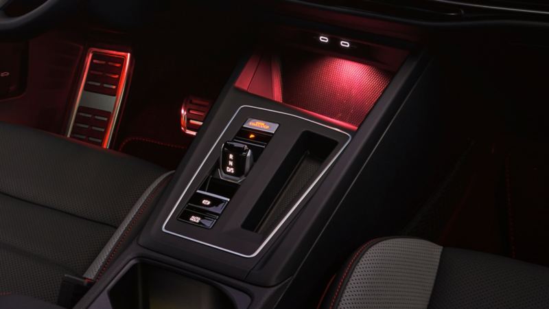 Red LED light 2023 Golf GTI interior featuring wireless charging, wireless Apple CarPlay® and Android Auto™.