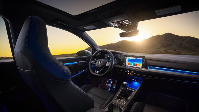 View on the premium front sport seats, heated steering wheel and the dashboard of the 2023 Volkswagen Golf R.