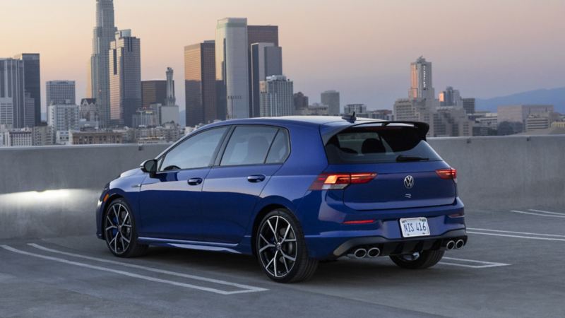 The back view of a parked 2024 Golf R facing the city
