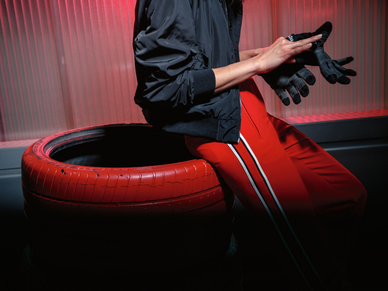 Mechanic sitting on recycled car tyre