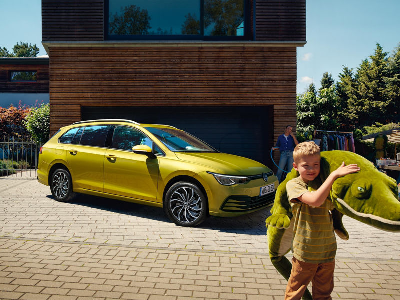 Child outside of house with Golf wagon in Gold 