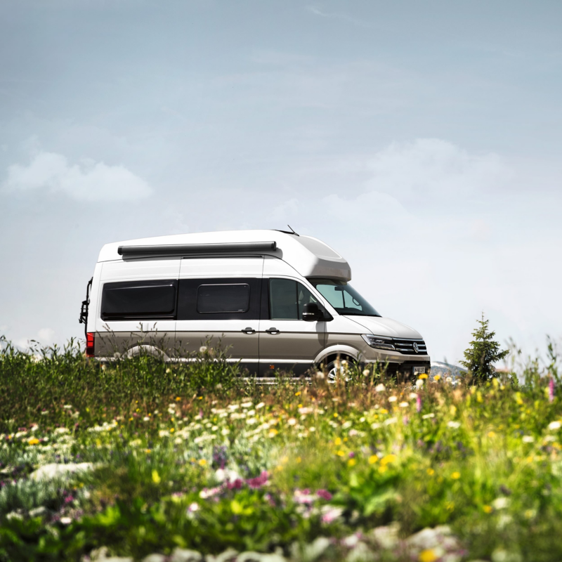 Grand California parked against a countryside background. 