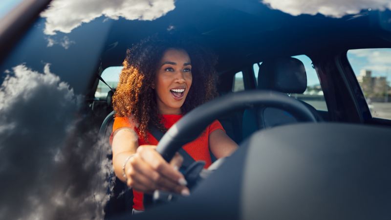 Close up on Volkswagen Tiguan R Steering wheel with the woman on the driving Seat