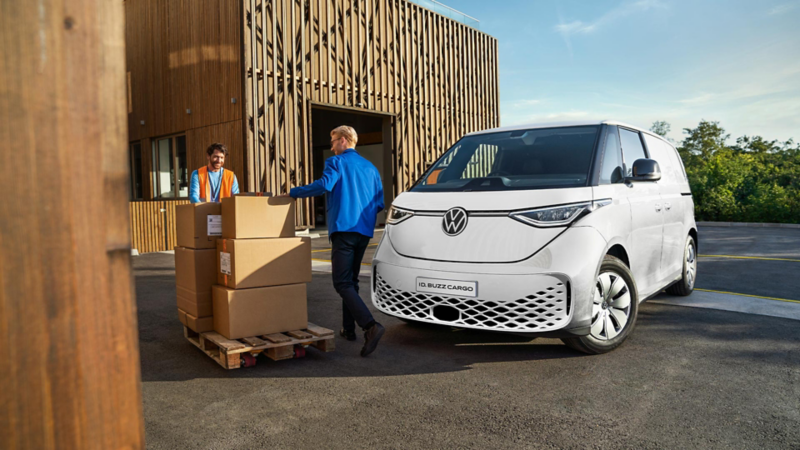 Volkswagen Transporter van which is parked outside a warehouse.