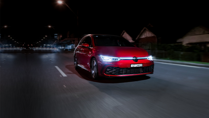 Volkswagen Golf GTI driving on the highway at night