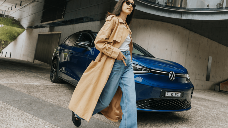 Woman walking in front of a blue ID. 4GTX