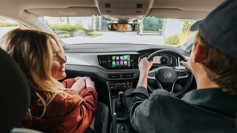 Couple in car front seats driving