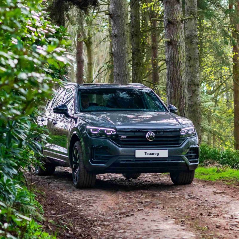 A VW Touareg driving along a woodland track