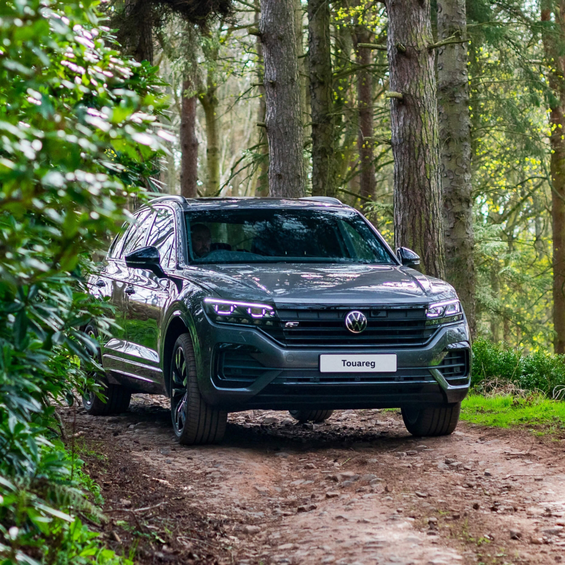 A VW Touareg driving along a woodland track