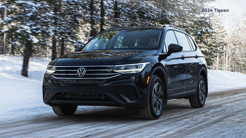 A Deep Black Pearl VW Tiguan Trendline on a wintery road.