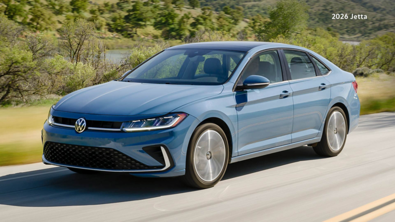 A Volkswagen Jetta drives along a smooth, sunlit road. 