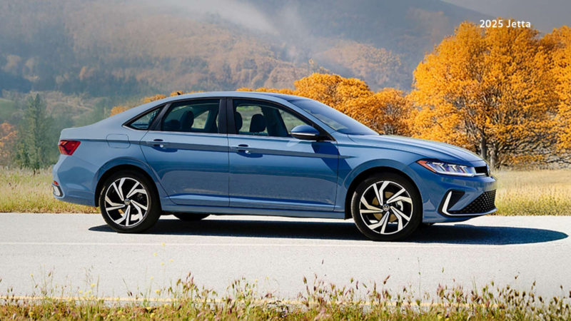 A Monterey Blue Pearl Jetta Highline parked on a road.