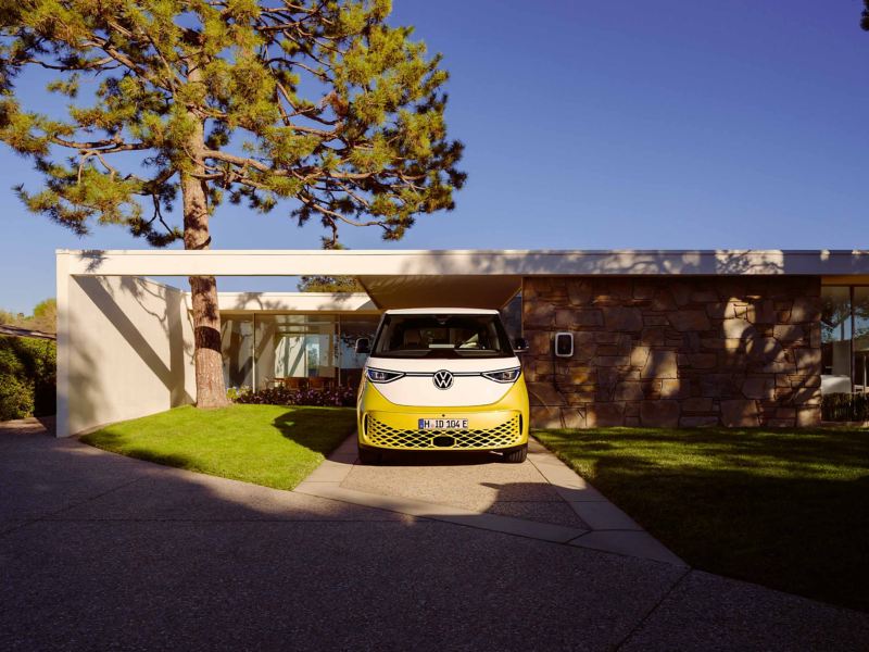 a yellow ID. Buzz parked by a beautiful leafy green tree