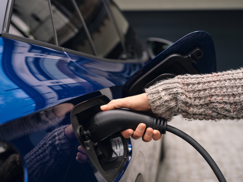 Detailed view of the charging process on a blue VW ID.4. 