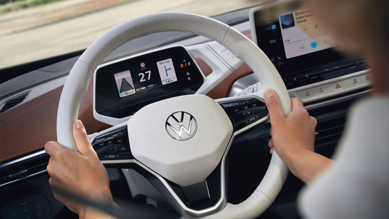 VW ID.4 interior, detail view of white multifunction steering wheel
