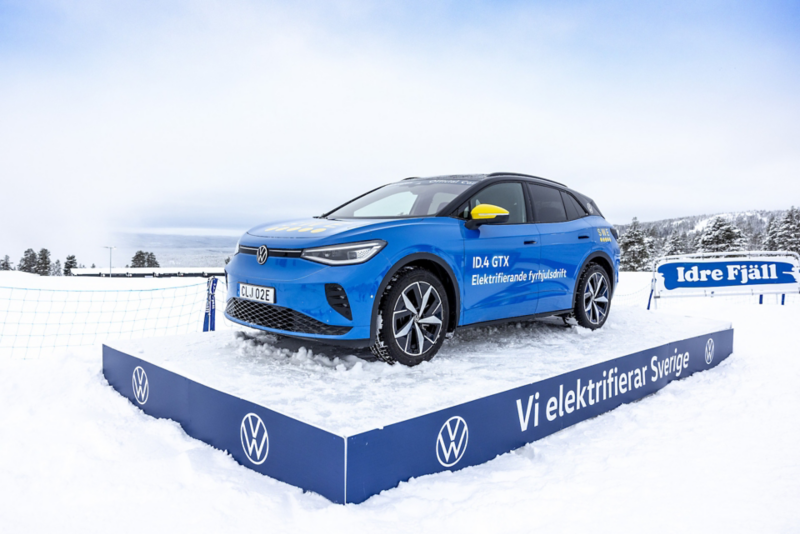 Blå Volkswagen ID.4 i snöklädda fjäll.